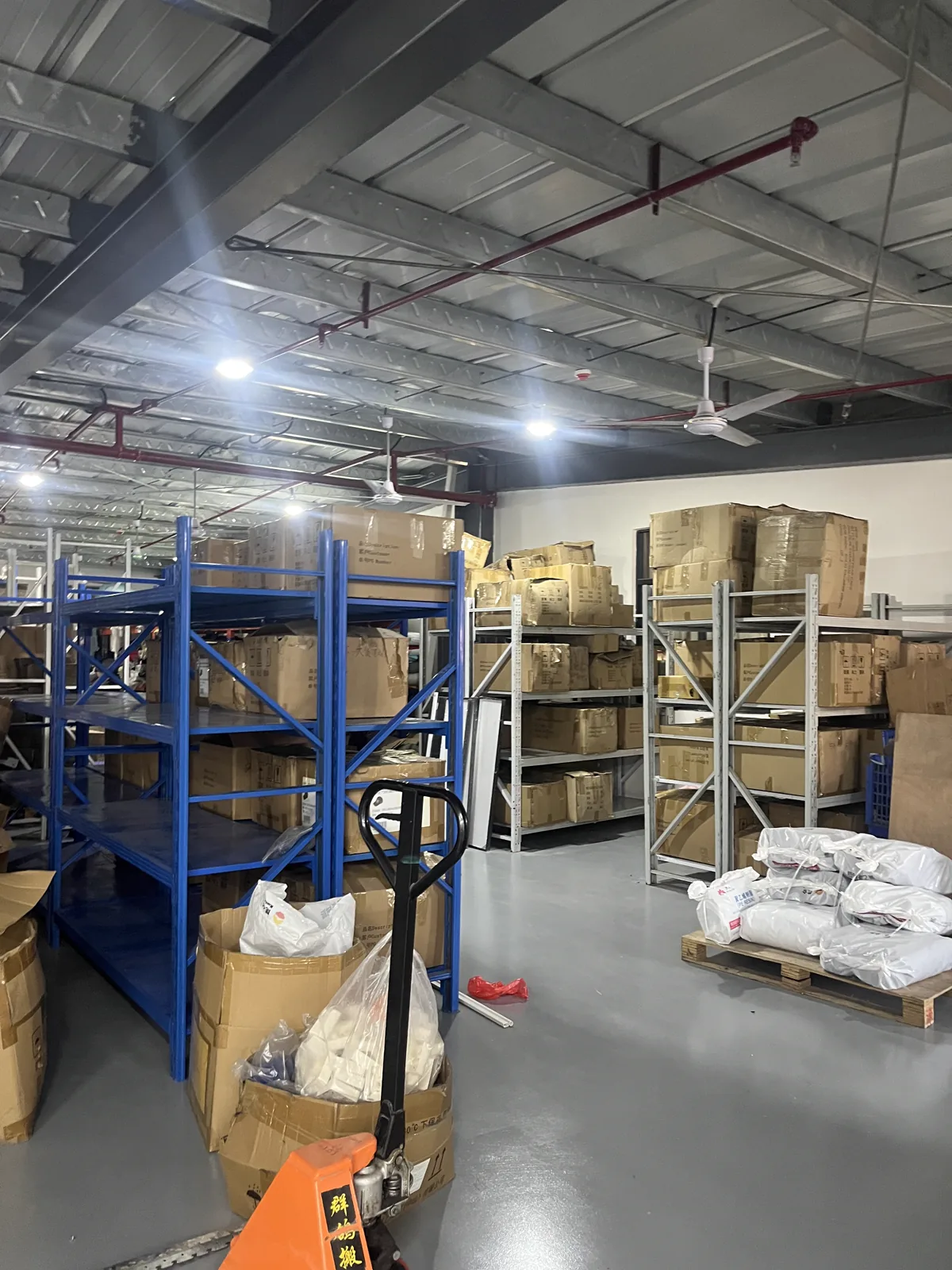 Raw materials and components organized in the SXMX factory warehouse